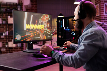 Gamer winning intense singleplayer spaceship arcade racing videogame on powerful gaming computer...