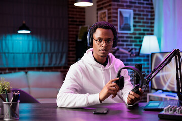 Portrait of gadgets reviewer internet celebrity recording show episode using professional...