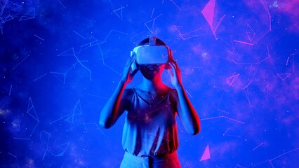 Excited smiling Asian woman looking around through VR to metaverse blue neon digital universe...