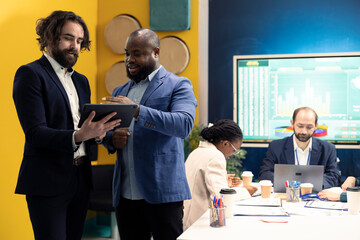 General director and CEO sharing insight about a new expansion strategy with their employees, presenting data reports an infographics to analyze business activity status. Coworkers in a meeting.