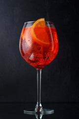 Aperol spritz cocktail with orange slice and ice