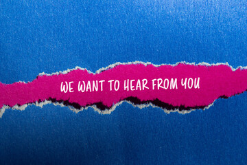 We want to hear from you message written on ripped blue paper with pink background. Conceptual we...