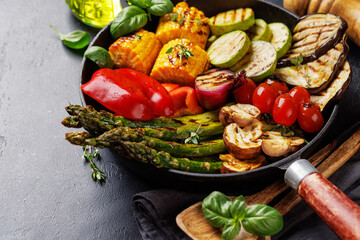 Assorted grilled vegetables on a frying pan, showcasing a colorful meal