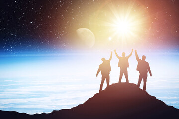 Silhouette of three people on the background of the planet, success concept. Elements of this image furnished by NASA