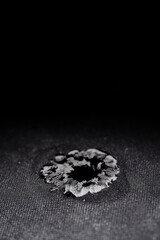 Bullet hole in composite body armour.