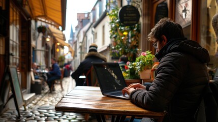 Serene Remote Work: Laptop Typing in Quaint European CafÃ© with Charming Architecture and Cobblestone Streets