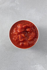 Canned whole peeled tomatoes with juice on table
