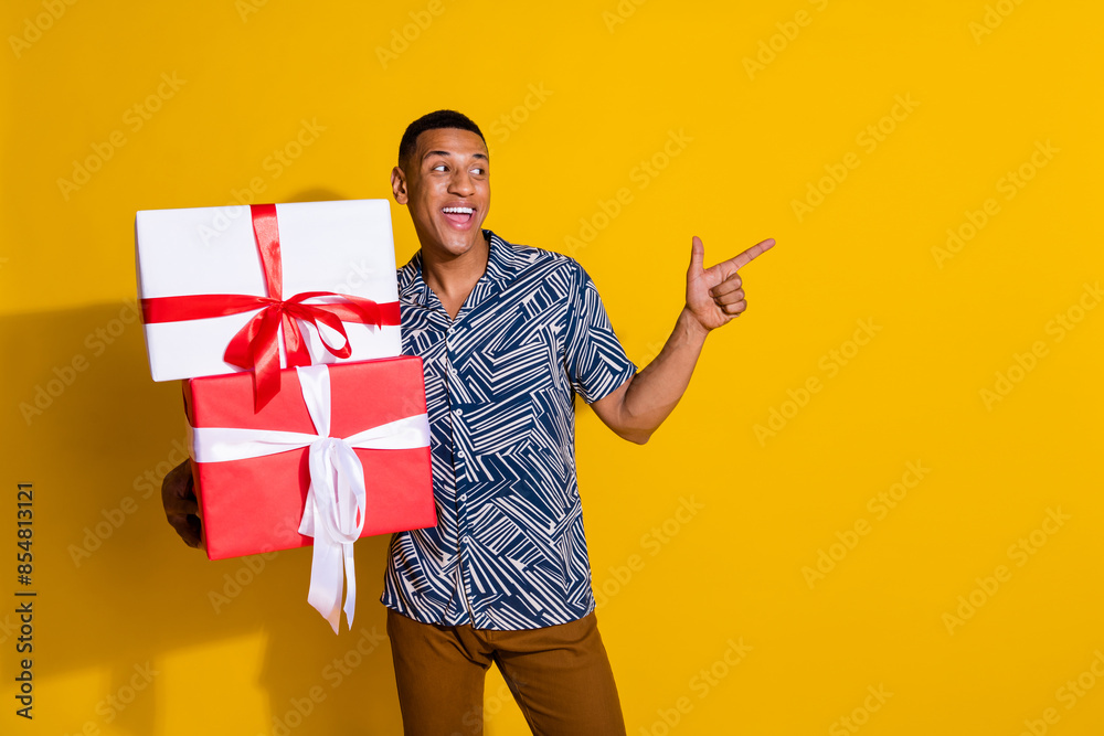 Canvas Prints Photo of funky cool guy dressed print shirt holding birthday gift showing empty space isolated yellow color background