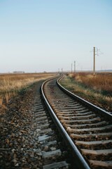 Fototapeta premium Picturesque railway tracks immersed in the mesmerizing colors of the setting sun