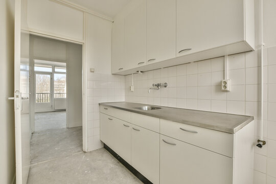 Spacious white kitchen with balcony view at Honselerdijkstraat 26