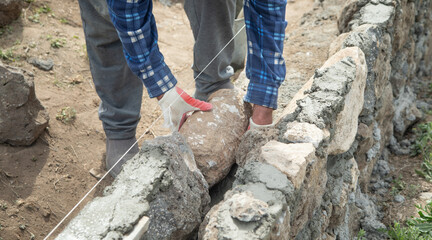 Craftsman working in rough stones in outdoor.