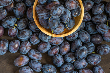 Plum variety Hungarian. Fruit harvest on the table in the kitchen. Autumn blue plum. Vitamin food bowl.