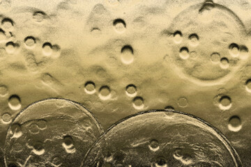 Craters on the metallic yellowish brown surface for background and the purpose of web and design use