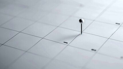 Minimalist Calendar with Single Pin Marking Important Date.