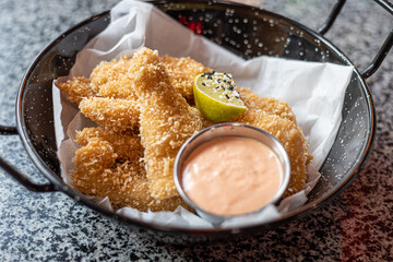 golden deep-fried battered chicken nuggets.succulent chicken chunks ensconced in a delectable...