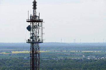 A 95 m high transmitter mast. Aerial view of mobile phone cell tower over forested rural area....