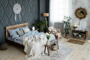 Cozy bedroom decor with natural elements like wooden accents, wicker baskets, and soft blankets....