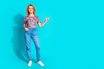Full size photo of pretty woman direct finger empty space wear t-shirt isolated on teal color background