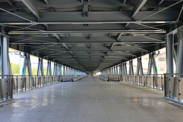 Pedestrian pathway or corridor or hallway between train station and building.	