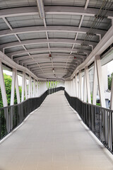 Pedestrian pathway or corridor or hallway between train station and building.	