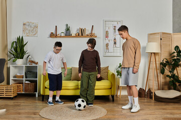 Three young boys playing with a soccer ball inside a home.