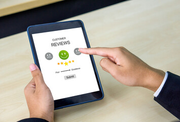 Closeup businessman hand holding a tablet computer. The screen show a five star rating.