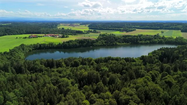 Steinsee bei Munchen Luftaufnahme. Steinsee, See in Bayern Luftbildansicht. Lake Stein aerial view near Munich, Bavaria, Germany. One of warmest lakes in Germany. Steinsee is located in forest area. 