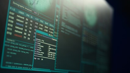 Close up shot of dangerous hacking code running on high tech computer system monitors. Programming scripts shown on PC displays in empty criminal hideout used by hackers to commit illegal activities