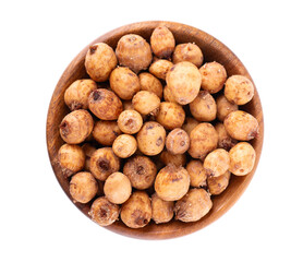 Tiger nuts in wooden bowl, isolated on white background. Pile of chufa nuts, earth almond or chufa sedge. Cyperus esculentus. Top view.