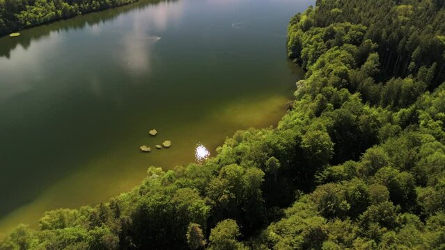 Steinsee bei Munchen Luftaufnahme. Steinsee, See in Bayern Luftbildansicht. Lake Stein aerial view near Munich, Bavaria, Germany. One of warmest lakes in Germany. Steinsee is located in forest area. 