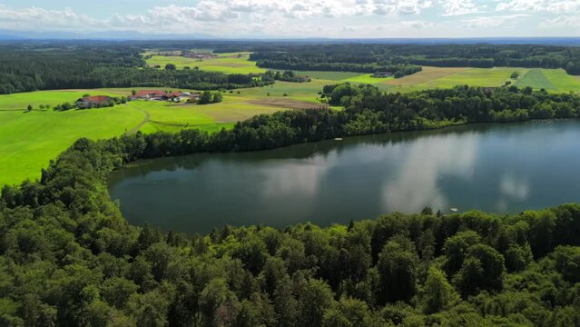 Steinsee bei Munchen Luftaufnahme. Steinsee, See in Bayern Luftbildansicht. Lake Stein aerial view near Munich, Bavaria, Germany. One of warmest lakes in Germany. Steinsee is located in forest area. 