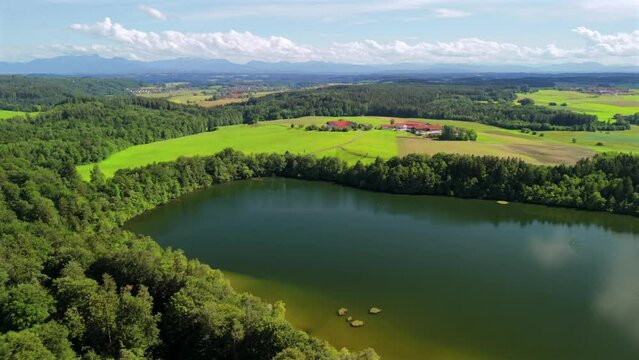 Steinsee bei Munchen Luftaufnahme. Steinsee, See in Bayern Luftbildansicht. Lake Stein aerial view near Munich, Bavaria, Germany. One of warmest lakes in Germany. Steinsee is located in forest area. 