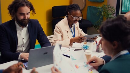 Management team developing new digital transformation initiatives in a boardroom meeting, enhance operational efficiency and agility. Employees improve organization workflow and performance. Camera B.