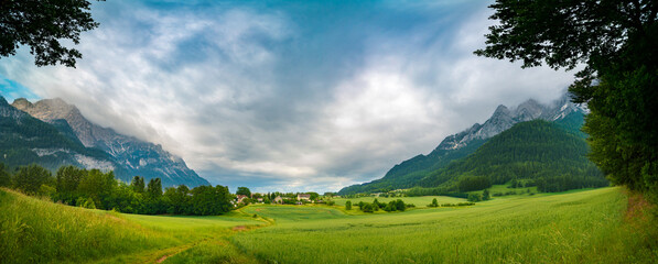 Fototapeta premium Green valley and village among the mountains