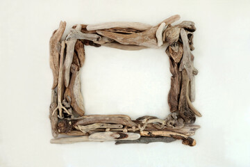 Driftwood wreath abstract frame on hemp paper background. Natural rectangular shape wood nature composition.
