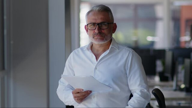 Smart lawyer analyzing documents on office close up. Serious entrepreneur looking on contract terms standing in office.
