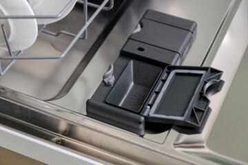 Open container, compartment of a dishwashing machine close up for dishwasher tablet