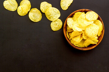 Homemade low calorie crispy potato chips in bowl, top view
