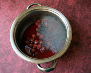 Mouldy food in a metal pot. Mold layer on a fruit compose