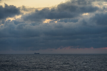 Cargo ship in the Baltic sea with thunderclouds.