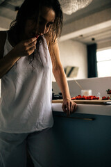 Beautiful woman in the kitchen preparing food. 