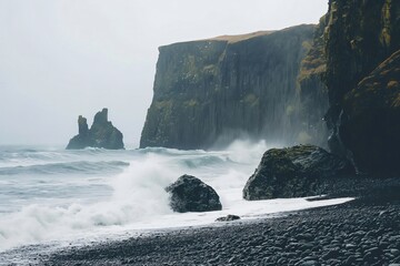 Serene rocky beach is framed by rugged cliffs with powerful waves crashing onto the shore, creating...