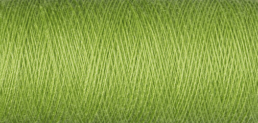 macro texture of a skein of green sewing thread