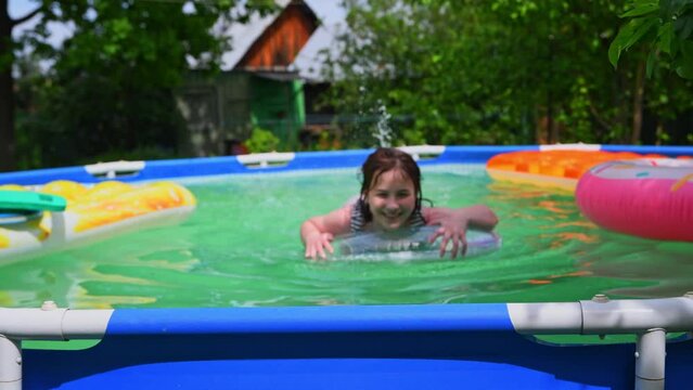 cute teenager girl swimming in frame pool outdoors, countryside, summer time, vacation, vacation