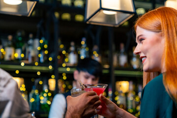 Caucasian man and woman dating and hanging out drinking alcoholic cocktail on holiday event at luxury restaurant bar. Cheerful people enjoy and fun meeting nightlife celebration party at nightclub.