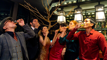 Group of Cheerful People toasting champagne glass celebrating holiday event party together at luxury restaurant bar. Happy man and woman friends enjoy and fun hangout meeting nightlife at nightclub.