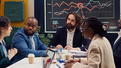 Public relations department working to improve the organization social media presence, attend an executive meeting. Studying trends and making decisions to corelate with company objectives. Camera A.