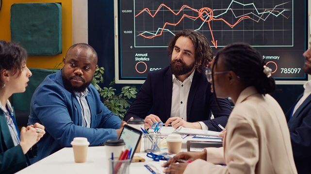 Public relations department working to improve the organization social media presence, attend an executive meeting. Studying trends and making decisions to corelate with company objectives. Camera A.