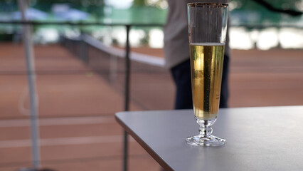 Elegant Glass of Sparkling Champagne on a Stylish Outdoor Table with Soft Background