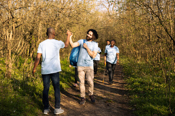 African american man sharing high five with his team of activists, praising each other after...